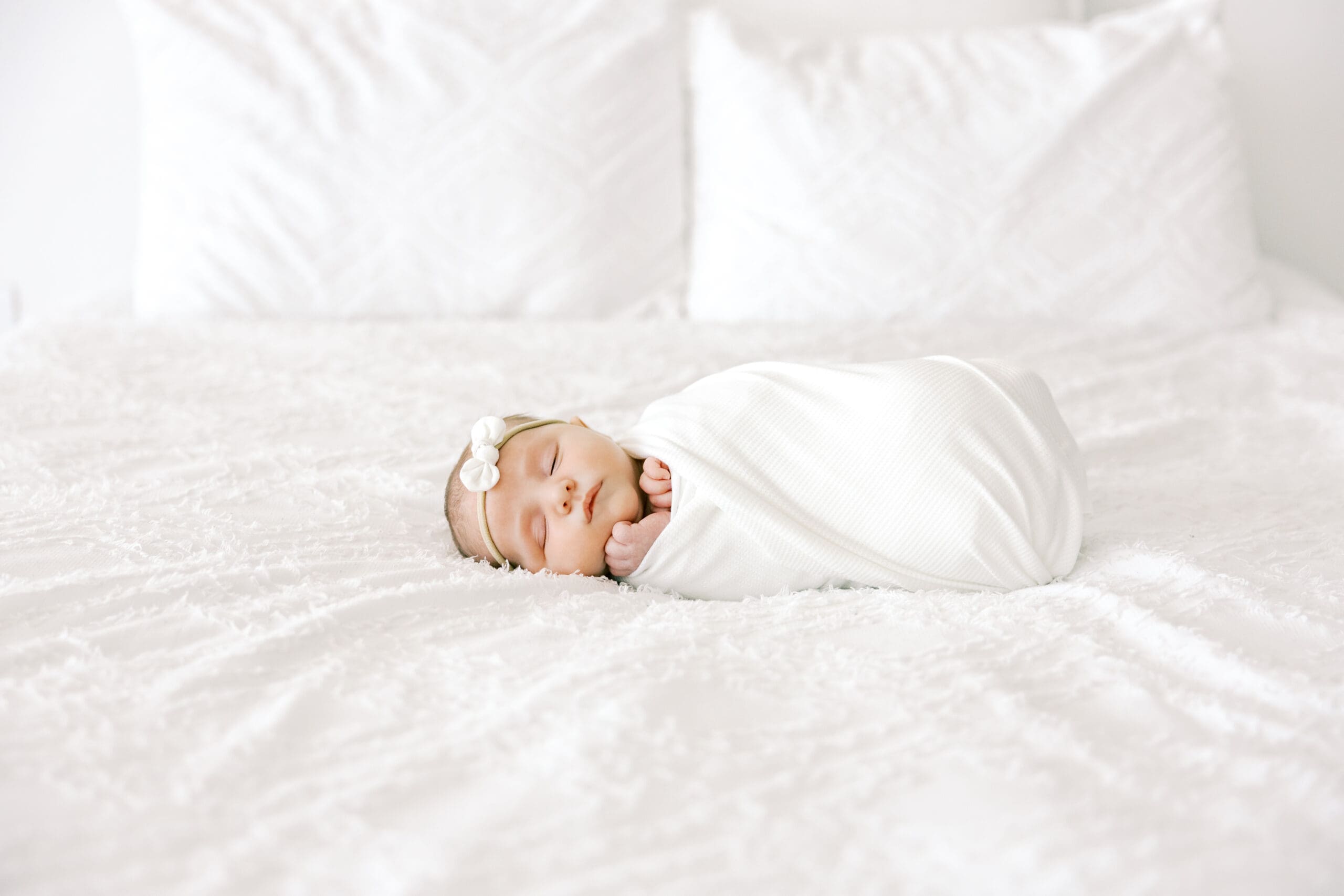 Newborn sleeping on the bed